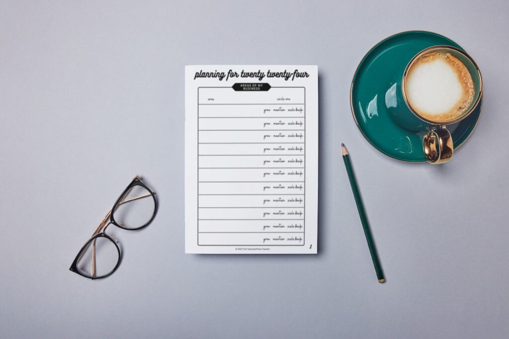 goal setting worksheet for piano teachers on desk with coffee pencil glasses
